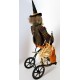 Vintage Primitive Folk Art HALLOWEEN GREEN WITCH on TRIKE by Sylvia Carlson.